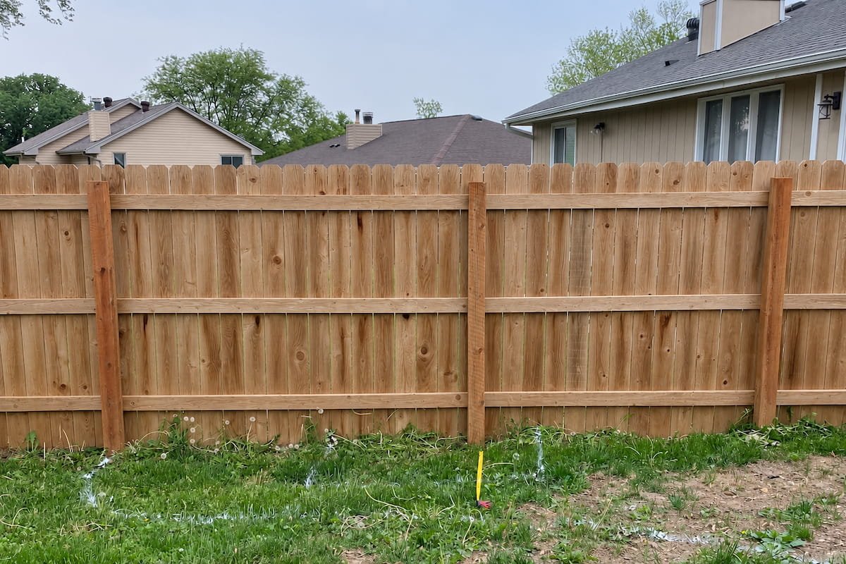 Restored wood privacy fence after professional cleaning in Ennis, TX