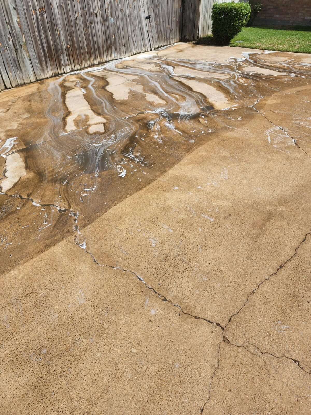 Concrete cleaning in Waxahachie, TX showing heavy surface buildup being removed