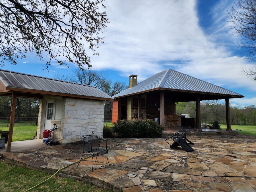 Patio and metal roof before cleaning in Rice, TX